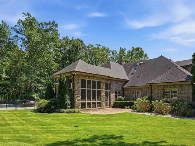 A flagstone patio provides a pleasant outdoor setting for this elegant brick and stone residence.
