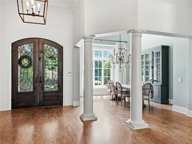 Gleaming hardwood floors and classic columns define this elegant entry flanking the dining area.