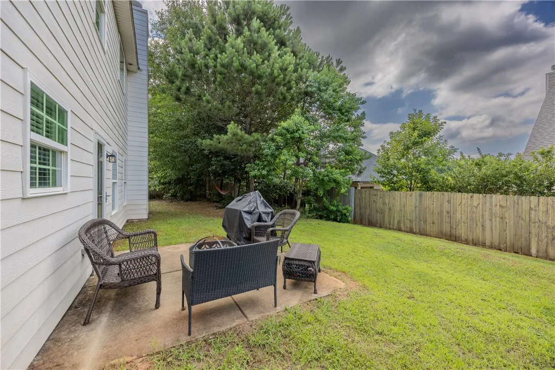 A spacious backyard with a cozy patio area and ample room for outdoor activities.