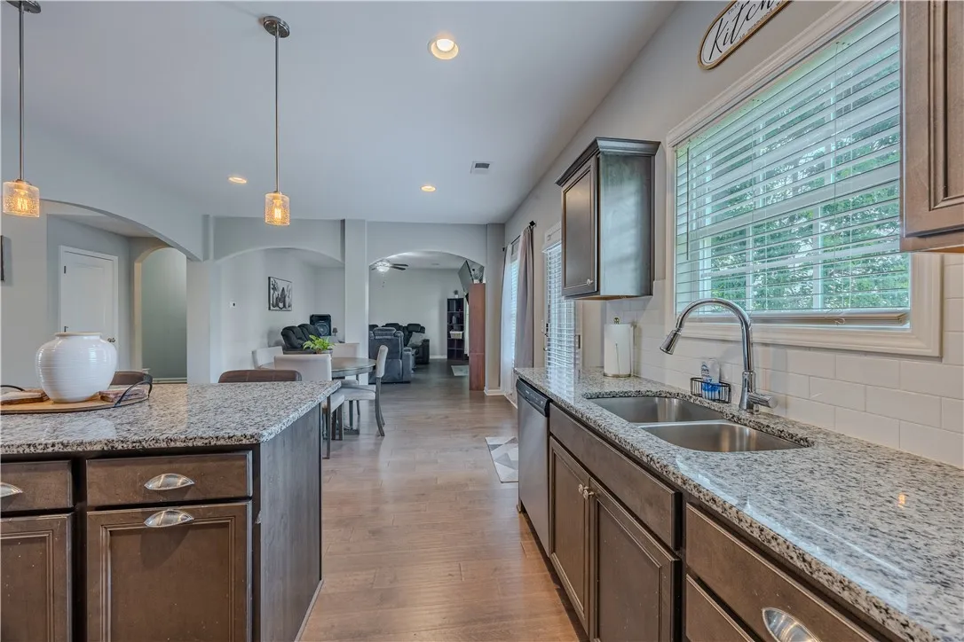 An inviting open floorplan seamlessly connects the well-appointed kitchen to the adjacent living spaces.
