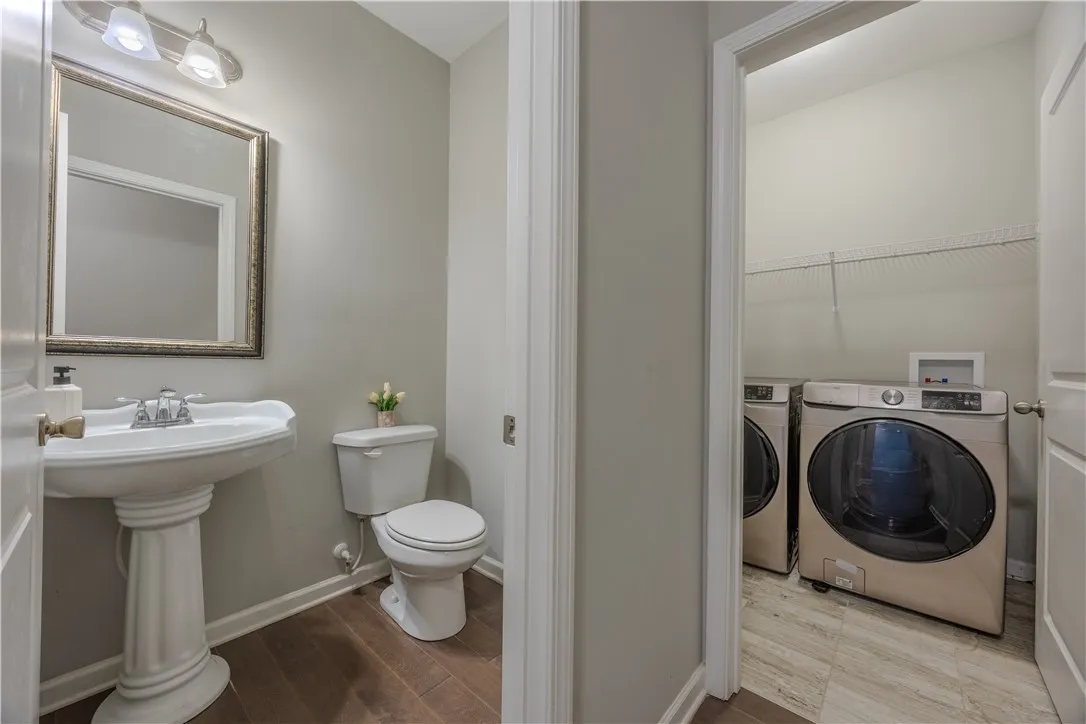 Functional layout combining a convenient powder room with an adjacent laundry area.