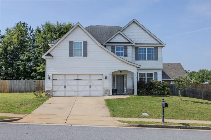 A classic two-story home with a neat front yard and welcoming entry.