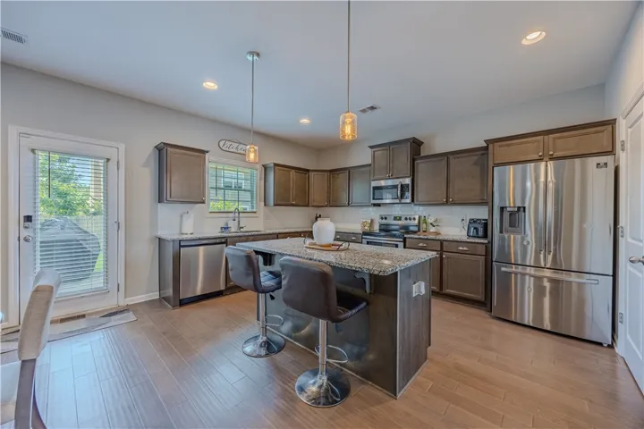 A well-appointed kitchen features a central island, ample cabinet space, and stainless steel appliances.