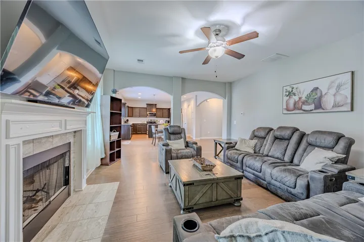 This family room features a cozy fireplace, setting the scene for relaxation and social gatherings.