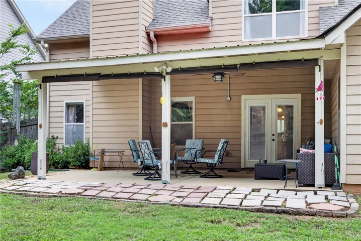 An inviting covered patio offers a comfortable outdoor living space for relaxation and entertainment.