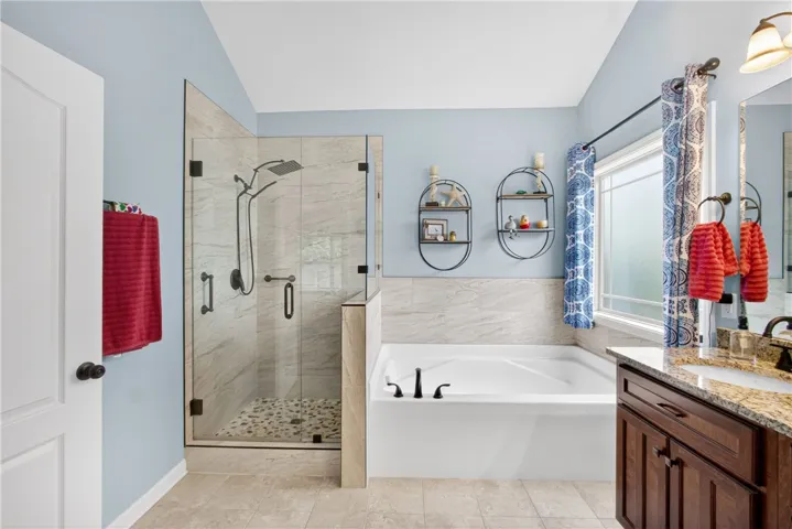 Luxurious bathroom with a spacious walk-in shower and a deep soaking tub, perfect for unwinding.