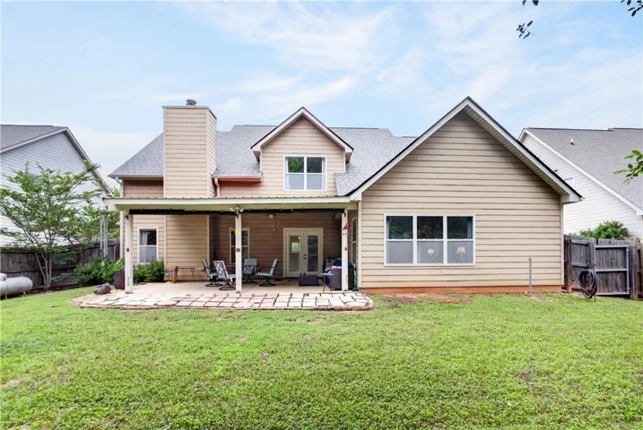 A well-maintained fenced yard offers a spacious covered patio perfect for outdoor enjoyment.