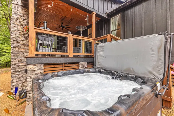 Unwind in the bubbling spa on the stone patio, just steps from the inviting covered deck.