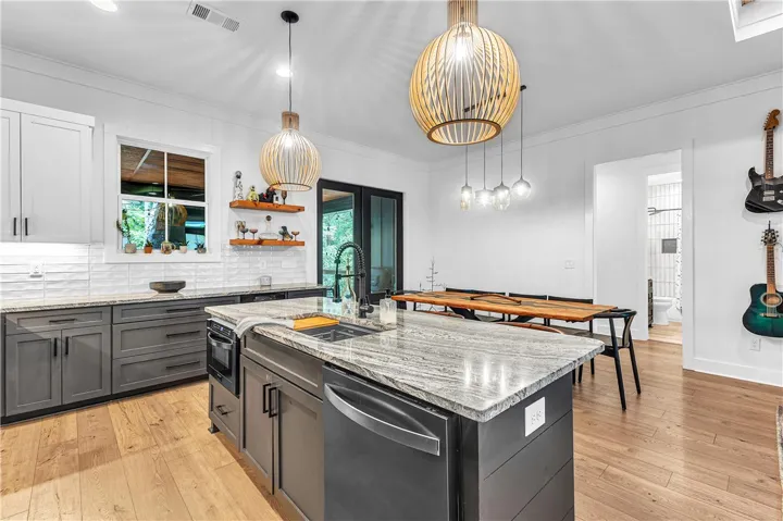 A well-appointed kitchen features a large island and ample cabinet space, perfect for culinary endeavors.