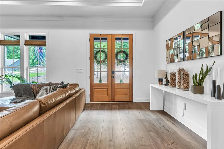 Natural wood flooring complements the welcoming front entry and spacious living area.