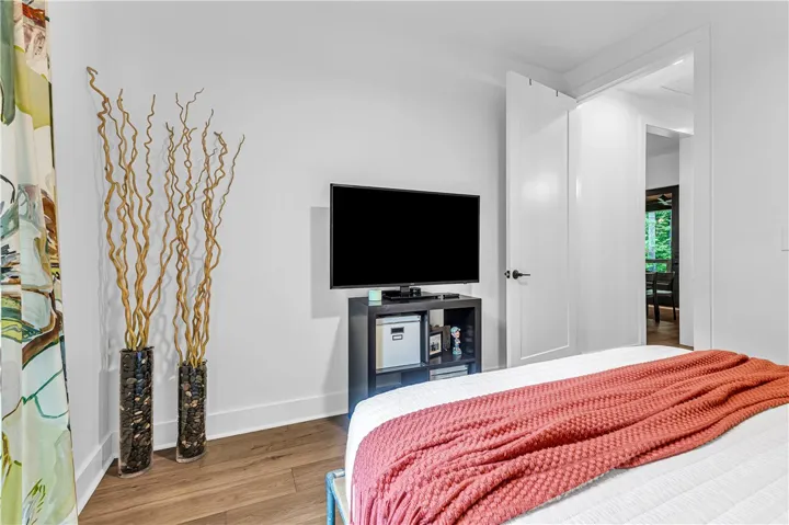 Hardwood floors and a clean, minimalist design define this peaceful bedroom retreat.