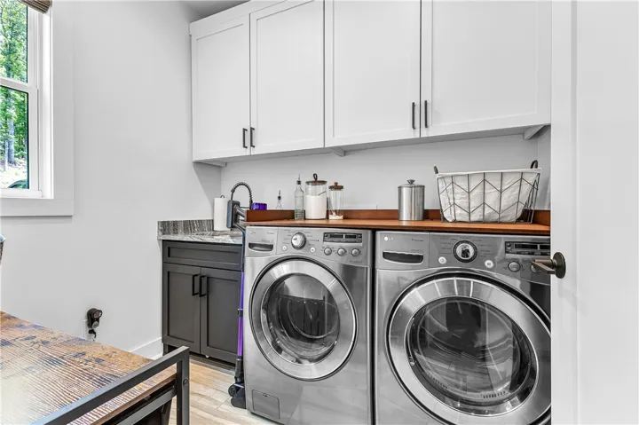 A well-appointed utility area features a functional sink, abundant cabinetry, and a sturdy countertop.
