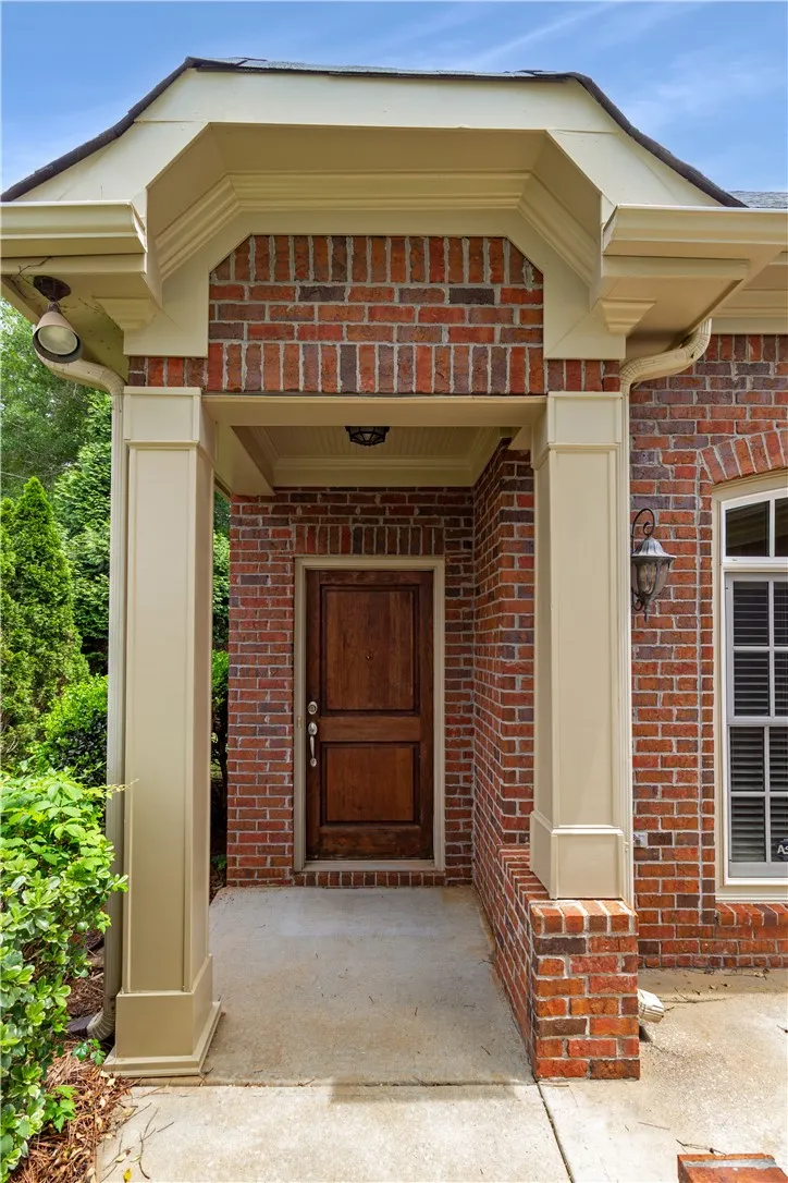 A welcoming brick facade with a prominent entry porch promises comfort.