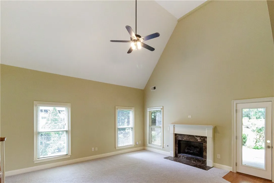 A spacious great room offers soaring vaulted ceilings and a classic fireplace.