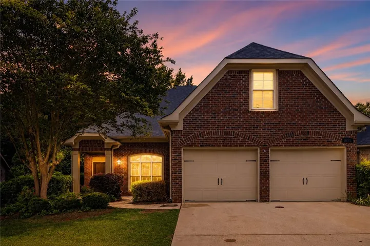 Brick facade with warm interior lighting creates a welcoming ambiance at twilight.