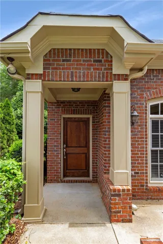 A welcoming brick facade with a prominent entry porch promises comfort.