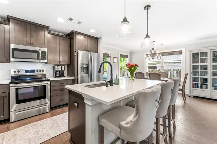 Culinary delights await in this contemporary kitchen, complete with a generous island and sleek appliances.