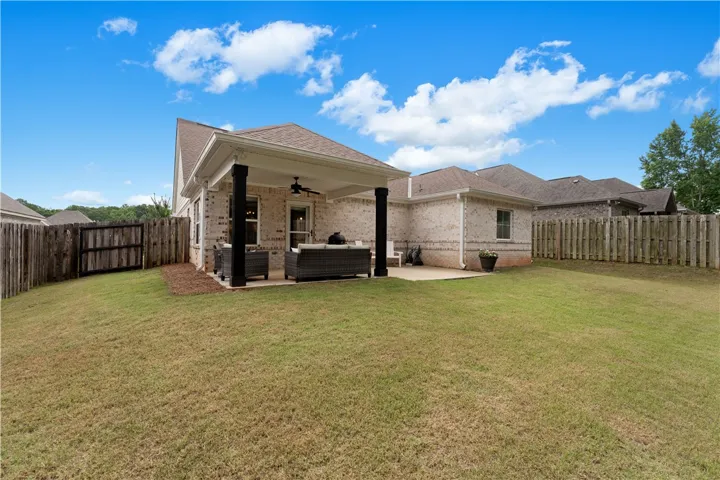 A spacious backyard with a private fence offers an ideal setting for relaxation.