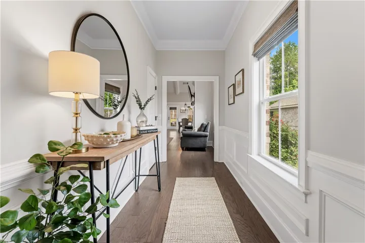 A graceful entry hall welcomes with rich hardwood flooring and classic wainscoting.