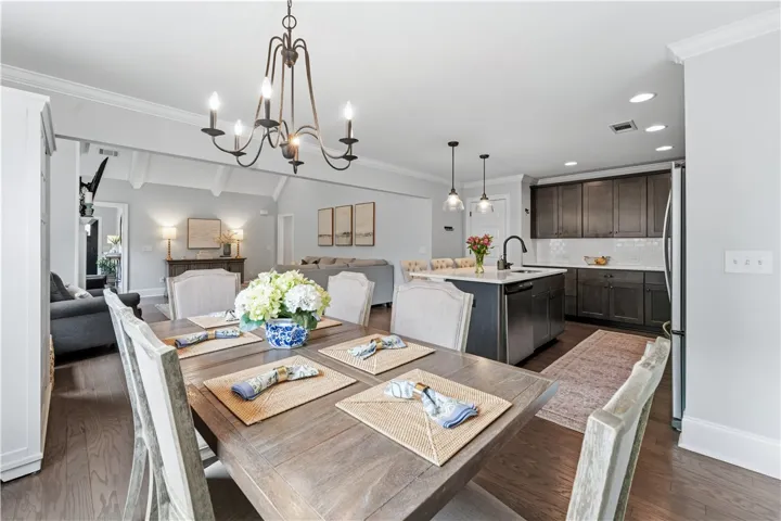 An inviting open-concept design seamlessly connects the dining area to the gourmet kitchen and living room.