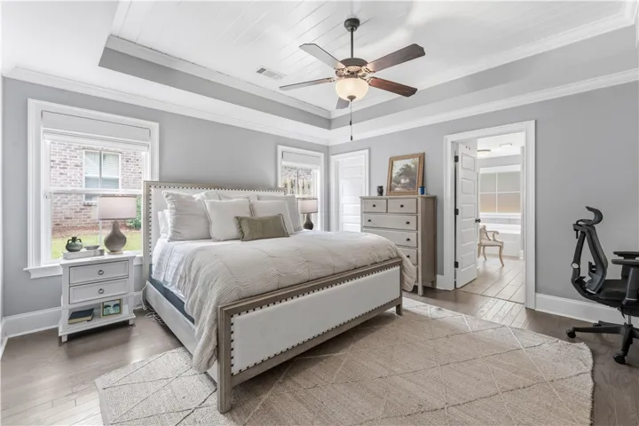Elegant tray ceiling with shiplap detail enhances this cozy primary​​‌​​​​‌​​‌‌​‌‌​​​‌‌​‌​‌​‌​​​‌​​ bedroom.