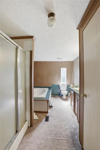 A functional bathroom layout offers a shower, bathtub, and vanity for daily routines.