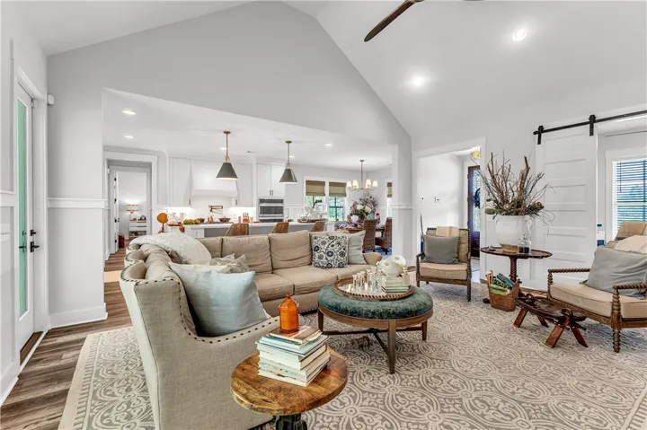 A spacious, open-concept living area with a vaulted ceiling flows seamlessly into a well-appointed kitchen.