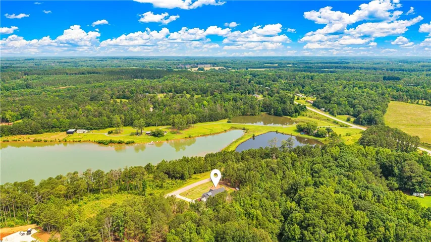 A tranquil estate nestled amidst lush woodlands and serene water bodies.