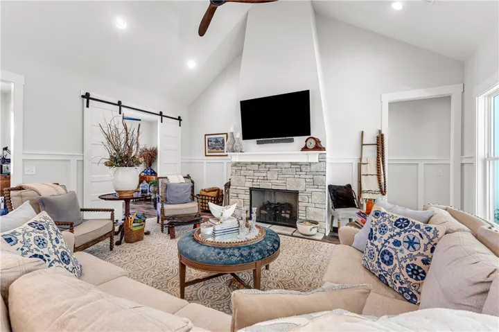 A comforting living area with vaulted ceilings and a stone fireplace, perfect for gathering.