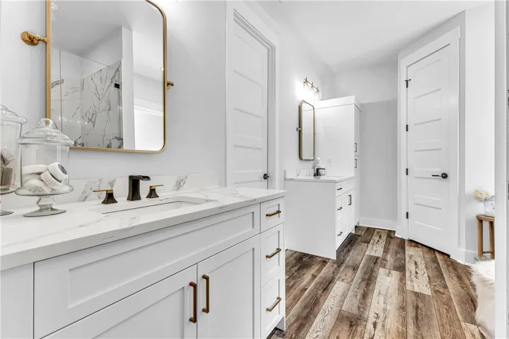 Sleek double vanity with modern fixtures and a spacious shower elevate daily routines.