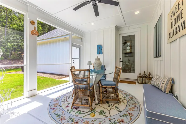A breezy screened porch offers an inviting outdoor retreat with ample space for relaxation and dining.