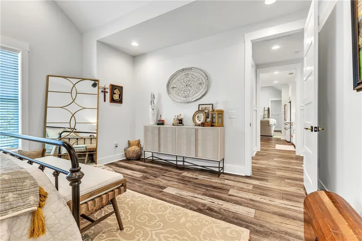 Hardwood floors and bright recessed lighting create a comfortable living space with seamless transitions.
