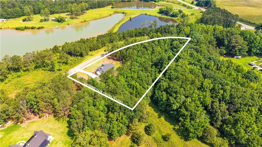 A tranquil, tree-lined property offering abundant privacy with water views and easy road access.