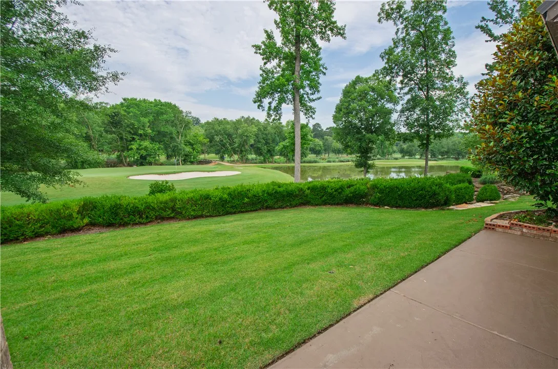 Enjoy tranquil golf course views and a serene lake from this well-maintained yard with a spacious patio.