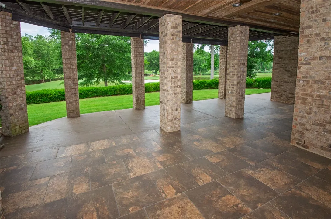 A spacious covered patio invites outdoor relaxation with verdant golf course vistas.