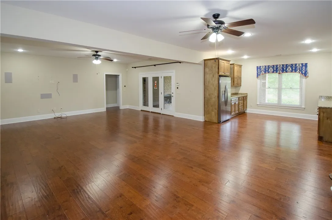 Rich hardwood floors unite an open concept living space, perfect for entertaining.