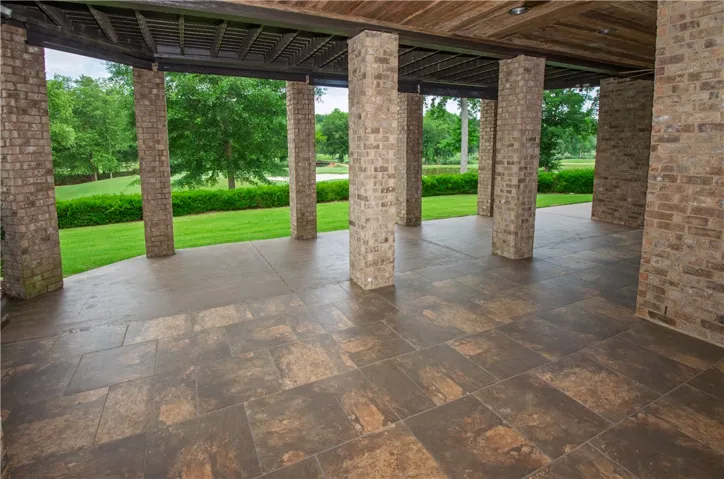 A spacious covered patio invites outdoor relaxation with verdant golf course vistas.