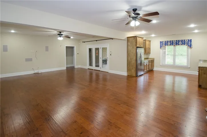 Rich hardwood floors unite an open concept living space, perfect for entertaining.