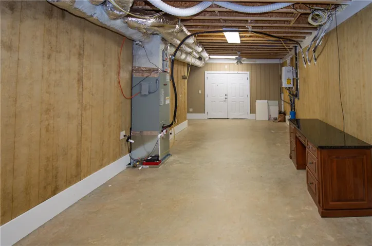 A spacious, unfinished basement offers versatile potential for future development.