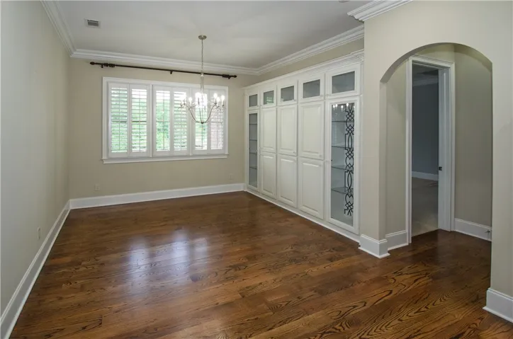 Hardwood floors and a sophisticated built-in cabinet define this versatile space.