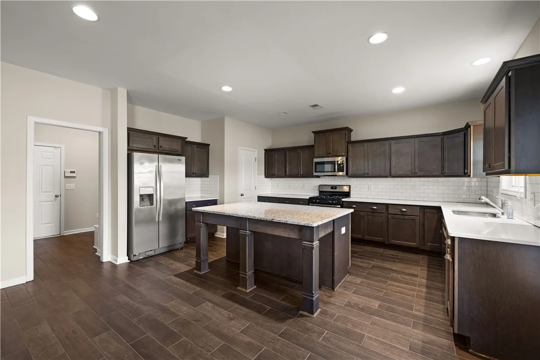 A well-appointed kitchen showcasing a central island and contemporary appliances.