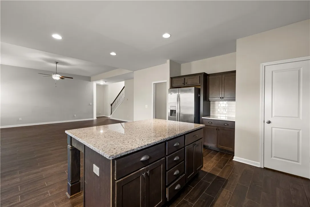 An inviting open-concept layout features rich hardwood flooring and a stylish kitchen island with ample storage.