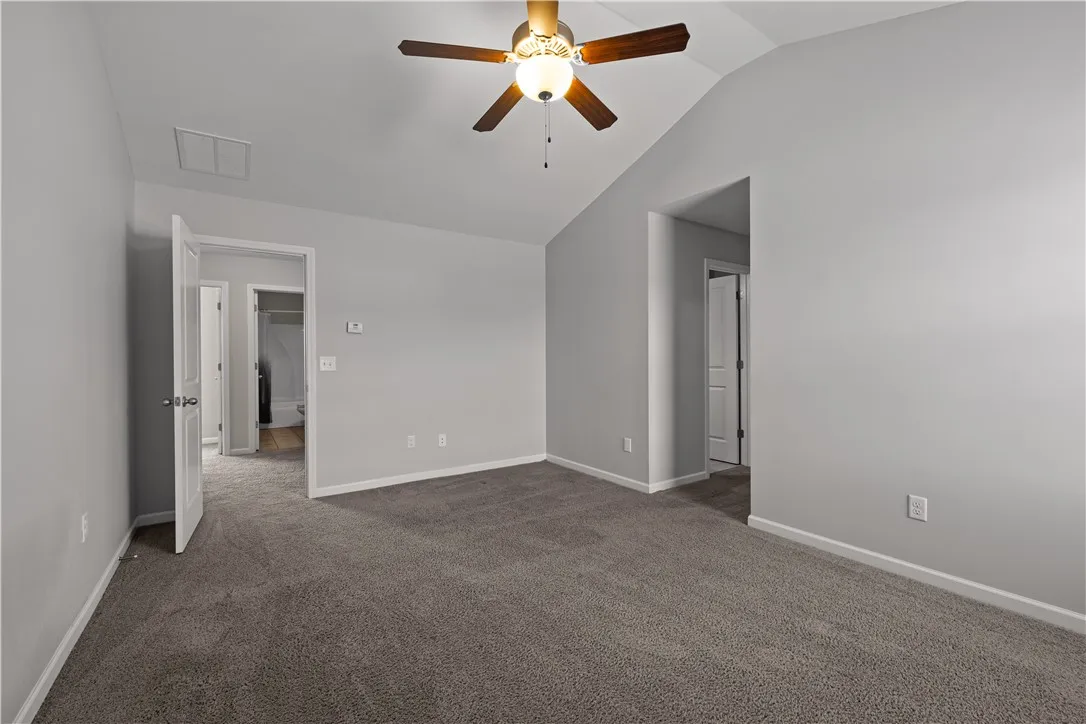 A well-lit bedroom with vaulted ceilings, creating an open and airy atmosphere.