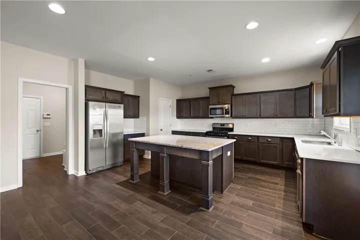 A well-appointed kitchen showcasing a central island and contemporary appliances.