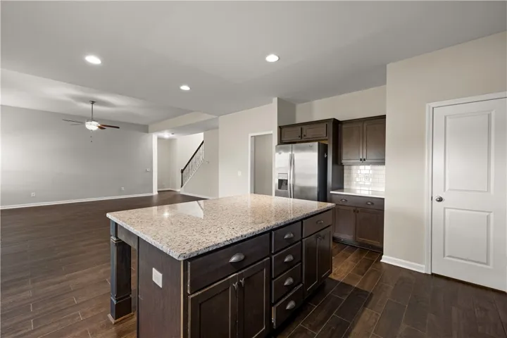 An inviting open-concept layout features rich hardwood flooring and a stylish kitchen island with ample storage.