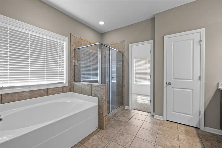 Indulge in a tranquil bathing experience with a dedicated shower and a separate soaking tub.