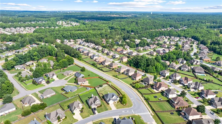 An aerial perspective reveals a serene suburban neighborhood with manicured yards and winding streets.