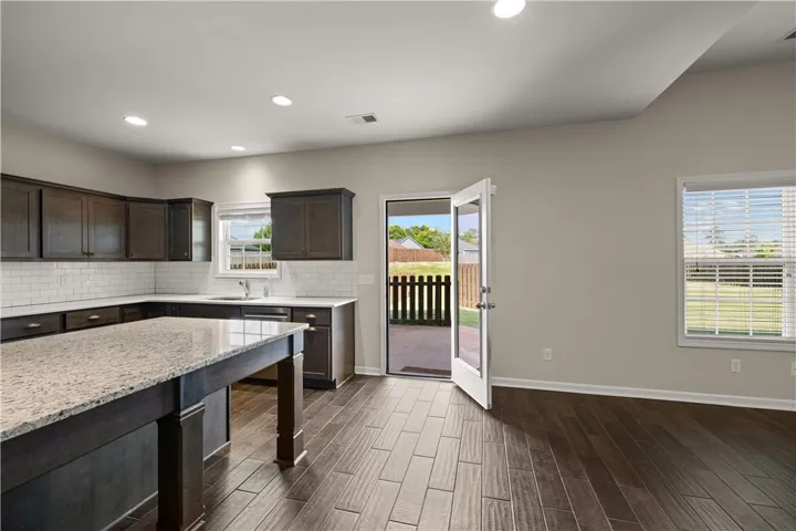 A well-appointed kitchen features rich cabinetry, generous counter space, and convenient outdoor access.