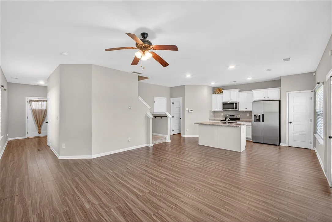 An open-concept living area flows seamlessly into a well-appointed kitchen, ideal for entertaining.