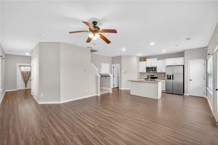 An open-concept living area flows seamlessly into a well-appointed kitchen, ideal for entertaining.